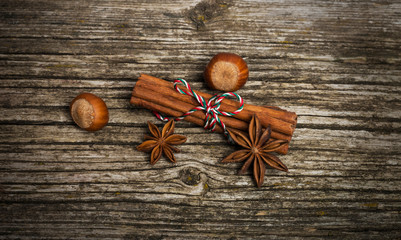 Star anise with cinnamon  at christmas time over old wood background.