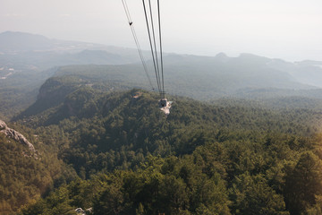 Mountain views from the cable car cabin to the top of Tahtali and the sea near the coast of Kemer, Antalya, Turkey