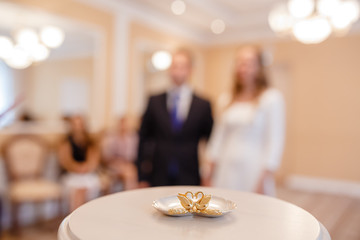 Moment in wedding, blur bride and groom holding hands and wedding guests in background