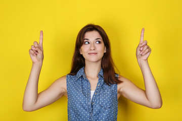 Young woman in stylish clothing on yellow background