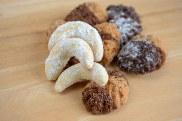 Cinnamon sandbakelse christmas sweets, two color, dark and light, vanilla crescent delicious cookies with sugar icing