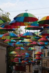 Fototapeta na wymiar Colorful umbrellas on tourist street