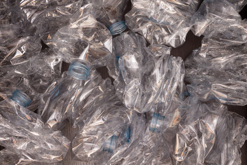 Plastic bottles background. Empty bottles on black surface