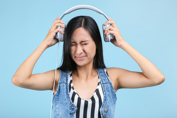 Beautiful woman with headphones on blue background