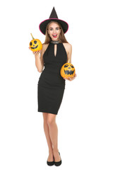 Beautiful woman in black costume holding halloween pumpkins on white background