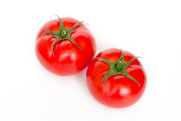A ripe red tomato with water drops isolated on a white background сlose up.  top view.