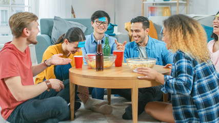 Obraz premium In the Living Room Diverse Group of Fun Loving Friends Playing 