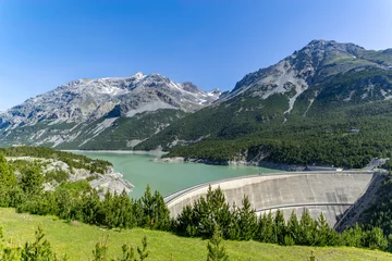 Gordijnen Huge dam with lake in the alps © Simone
