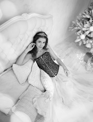 a beautiful girl like Cinderella in a Christmas fairy tale lies on a bed