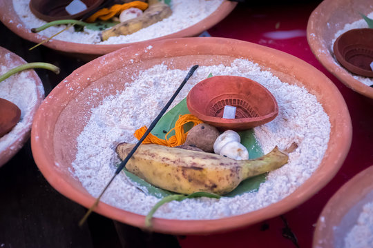 Soil malasa with supari or betel nut, banana, pan pata or betel Leaf, incense sticks, flowers, sand isolated on blurred background. Essential in Hindu ritual Tarpan.