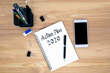 2020 action plan in a notebook with a pen