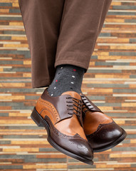 fashionable men's shoes with beautiful feet in socks