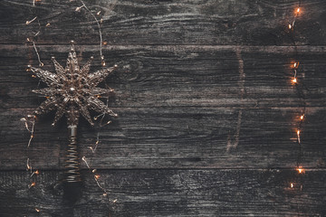 Christmas star on a gray background with garlands. New Year's scenery