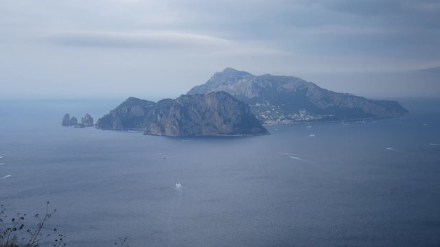 panorama of Capri in a cloudy day seen from the path that leads to Punta Campanela a protected marine natural area. Sorrento Peninsula,  Campania, Naples, Italy