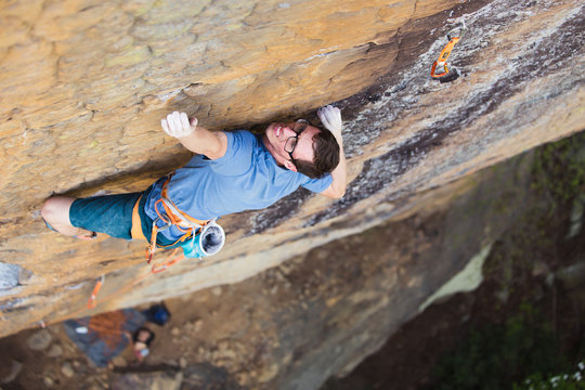Rock climber with big fingers holding onto nothing