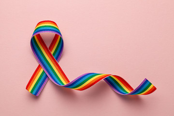 LGBT rainbow ribbon pride symbol. Stop homophobia. Pink background