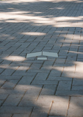 pointer arrow on the pavement tiles