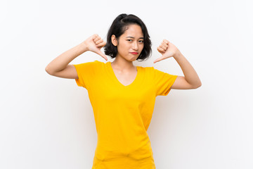 Asian young woman over isolated white background showing thumb down