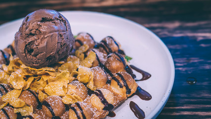 Waffle topped with chocolate ice cream , banana and wipe cream . Chocolate coffee ice cream ball