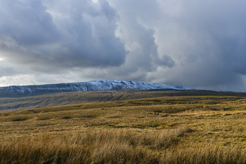 View up to a snow covered Whernside