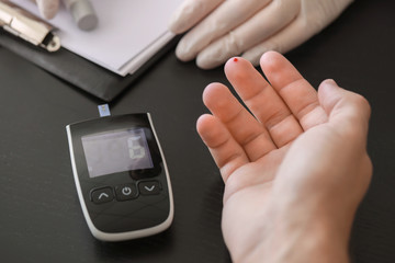 Diabetic man after taking blood sample in clinic, closeup