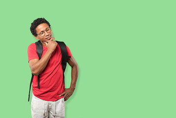 Happy young man making a gesture of doubt