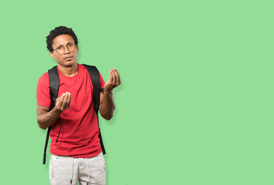 Confused young man making an italian gesture of not understand