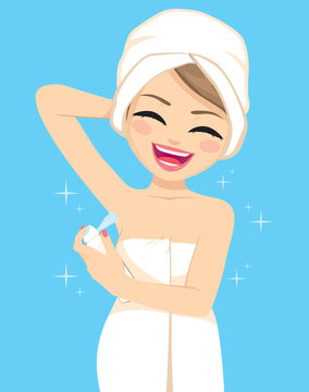 Happy young woman wearing white towel on head and body using deodorant spray after shower