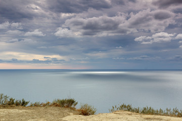calm landscape sea merging on the horizon with cloudy sky