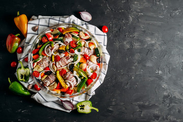 Meat with vegetables. Meat rolls with bacon. Baked vegetables, zucchini, tomato, pepper. Spices and herbs. Top view