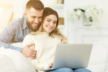 Obraz na płótnie Canvas Online video-call. Happy couple using laptop, free space