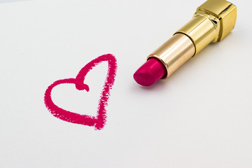 Pink heart sign drawn eith a lipstick isolated on white background