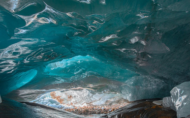 beautiful blue ice glacier cave grotto inside the mountain glacier Alibek, Dombay