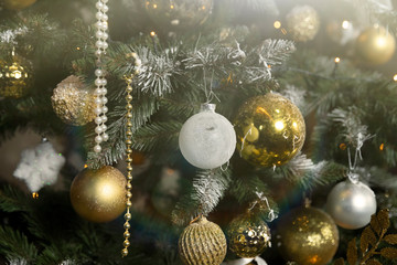 Close-up of a beautifully decorated Christmas tree with garlands and toys before the holiday