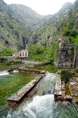 Medieval European architecture in the green mountains. Waterfall in Kotor, Montenegro.