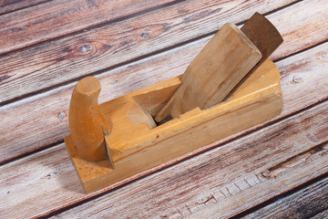 Old wood plane on a wooden background