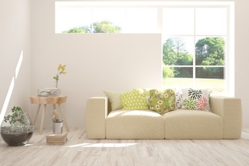 Stylish room in white color with sofa and summer landscape in window. Scandinavian interior design. 3D illustration