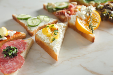 Tasty sandwiches on light background