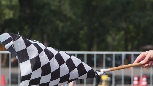 Waving checkered race flag close up. Flag which announces the final lap of the race on a finish line 4k