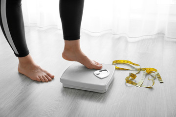 Woman with scales at home. Weight loss concept