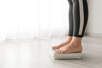 Woman standing on scales. Weight loss concept