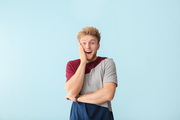 Portrait of excited man on color background