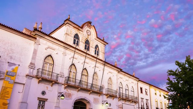 Evora, Portugal. View of the Town Hall in Evora, Portugal during the sunset. Beautiful landmark with colorful sky in summer. Time-lapse in the evening, zoom in
