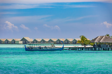 Maldives beach landscape, Dhoni wooden boat and luxury water villas with sea view