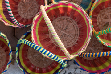 Colorful wicker baskets handmade. Weaving of bamboo and rattan.