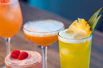 Close-up selection of alcoholic cocktails on a table.