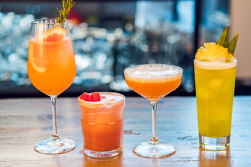 Selection of alcoholic cocktails at bar background.