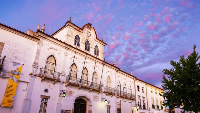 Evora, Portugal. View of the Town Hall in Evora, Portugal during the sunset. Beautiful landmark with colorful sky in summer. Time-lapse in the evening
