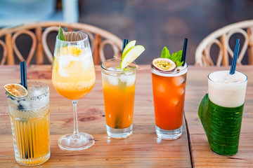 Selection of alcoholic and milkskake cocktails at bar background.