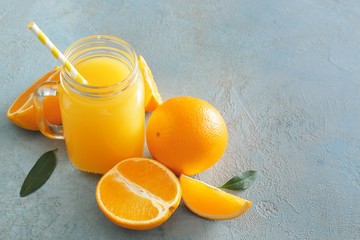 Naklejka na ściany i meble Mason jar of fresh orange juice on table
